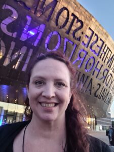 Julie in front of the Wales Millennium Centre in Roald Dahl Plass in Cardiff, Wales